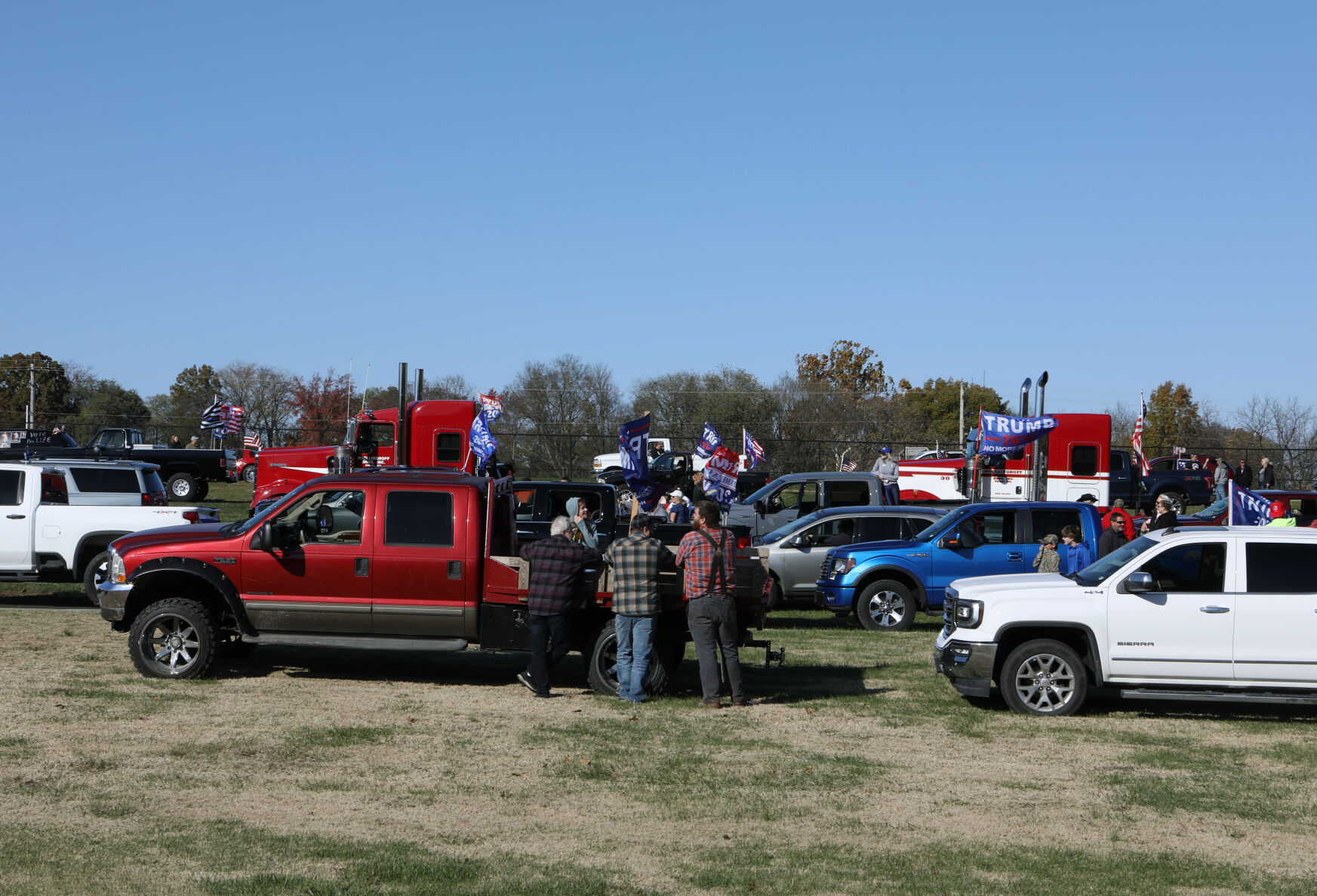 People wait by their cars before parade